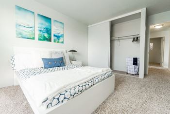 A bedroom with a bed and a closet